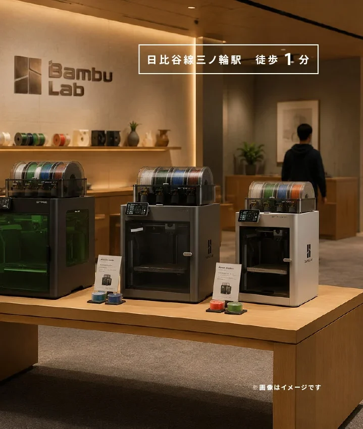 Render of the Brule Bambu Lab authorized store in Tokyo: three Bambu printers with AMS units on a wooden display table, filament shelf and Bambu Lab logo on the wall